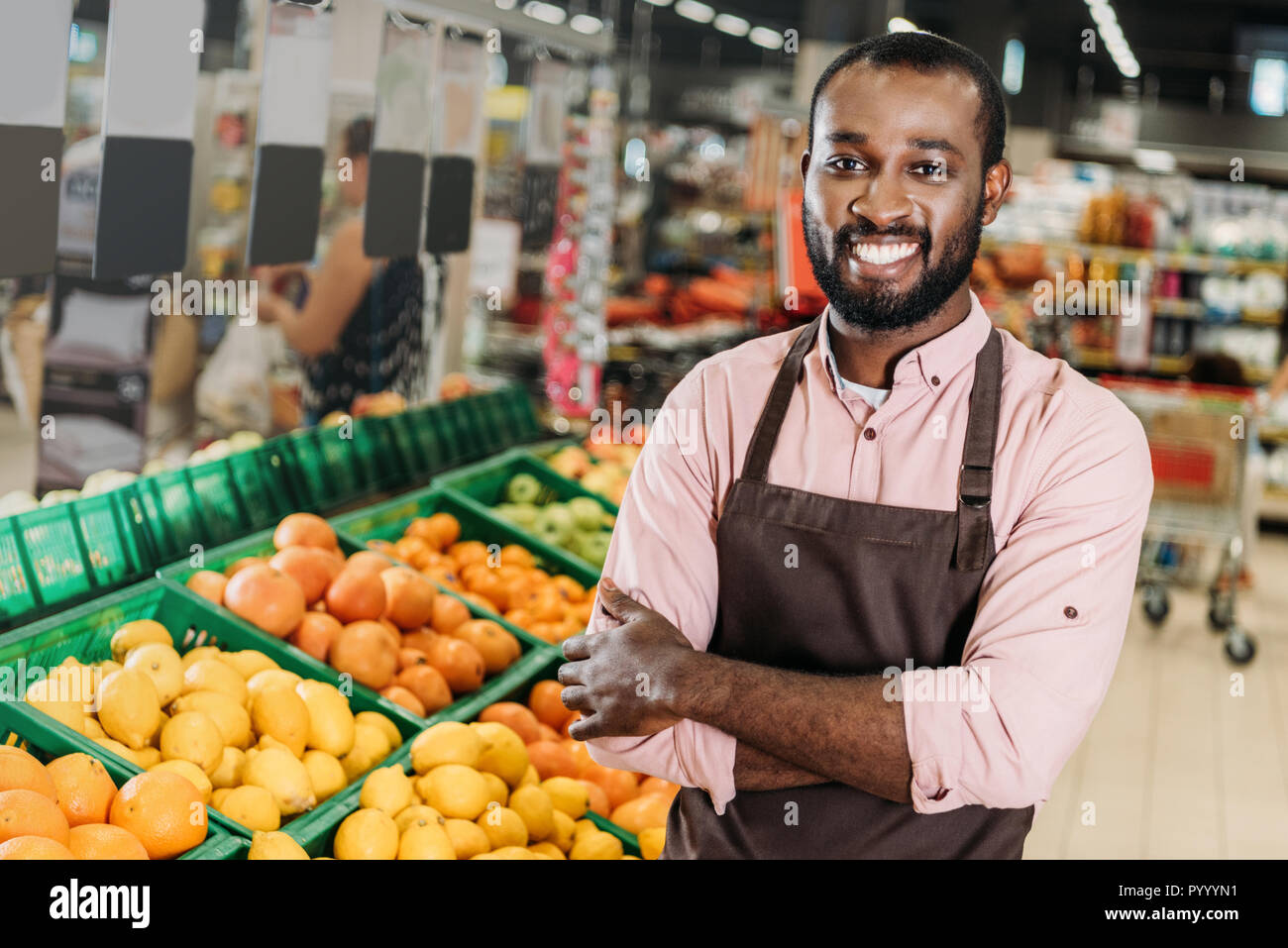 Small-business shop assistant standing in a produce store