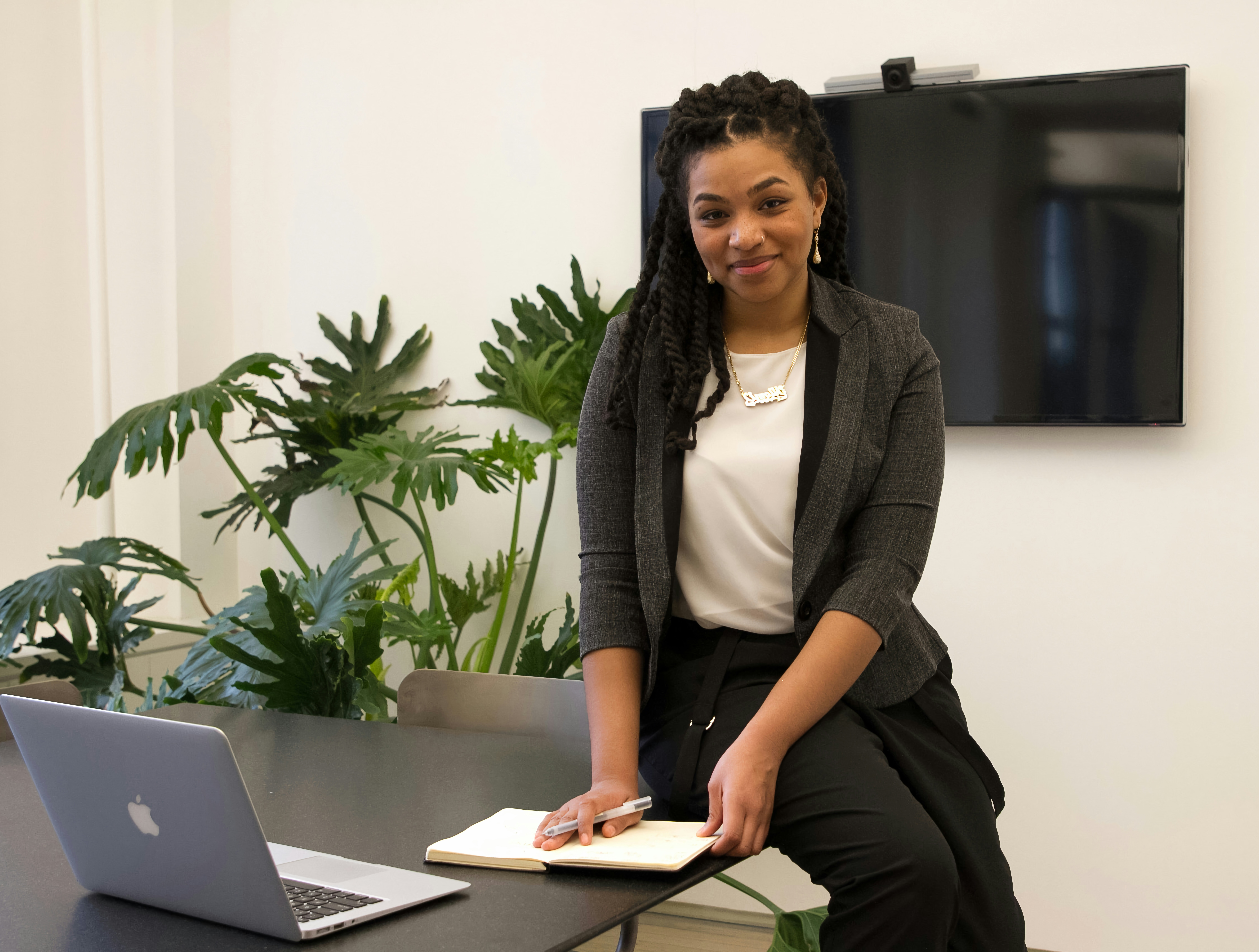 Small-business owner working beside her laptop and notebook