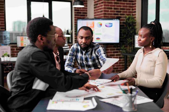 Growing small-business team reviewing plans together